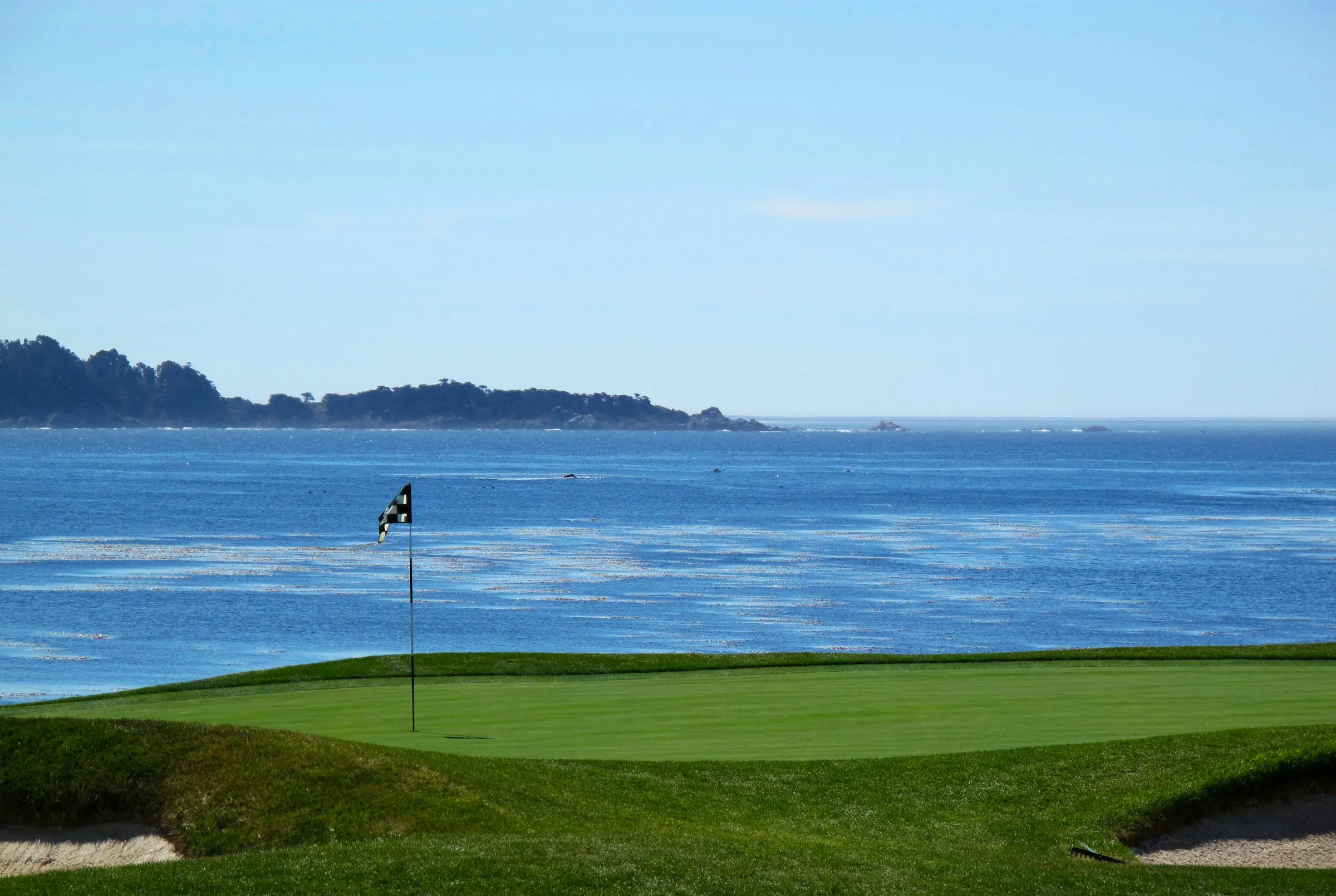 Golf course with ocean in background